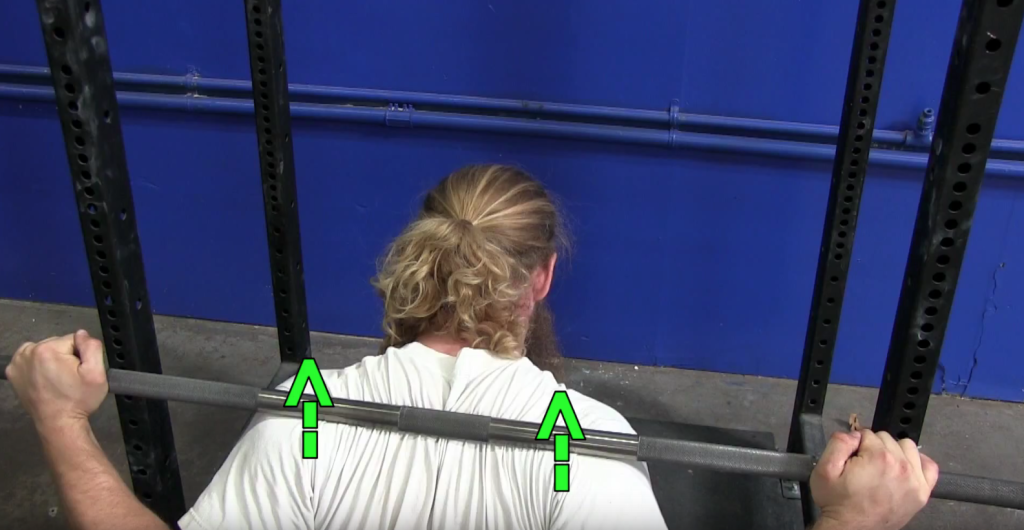 Driving your back through the barbell during squat