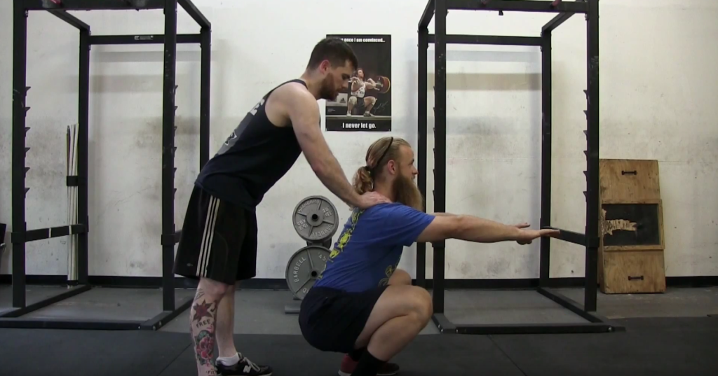 squat technique cue hands on back